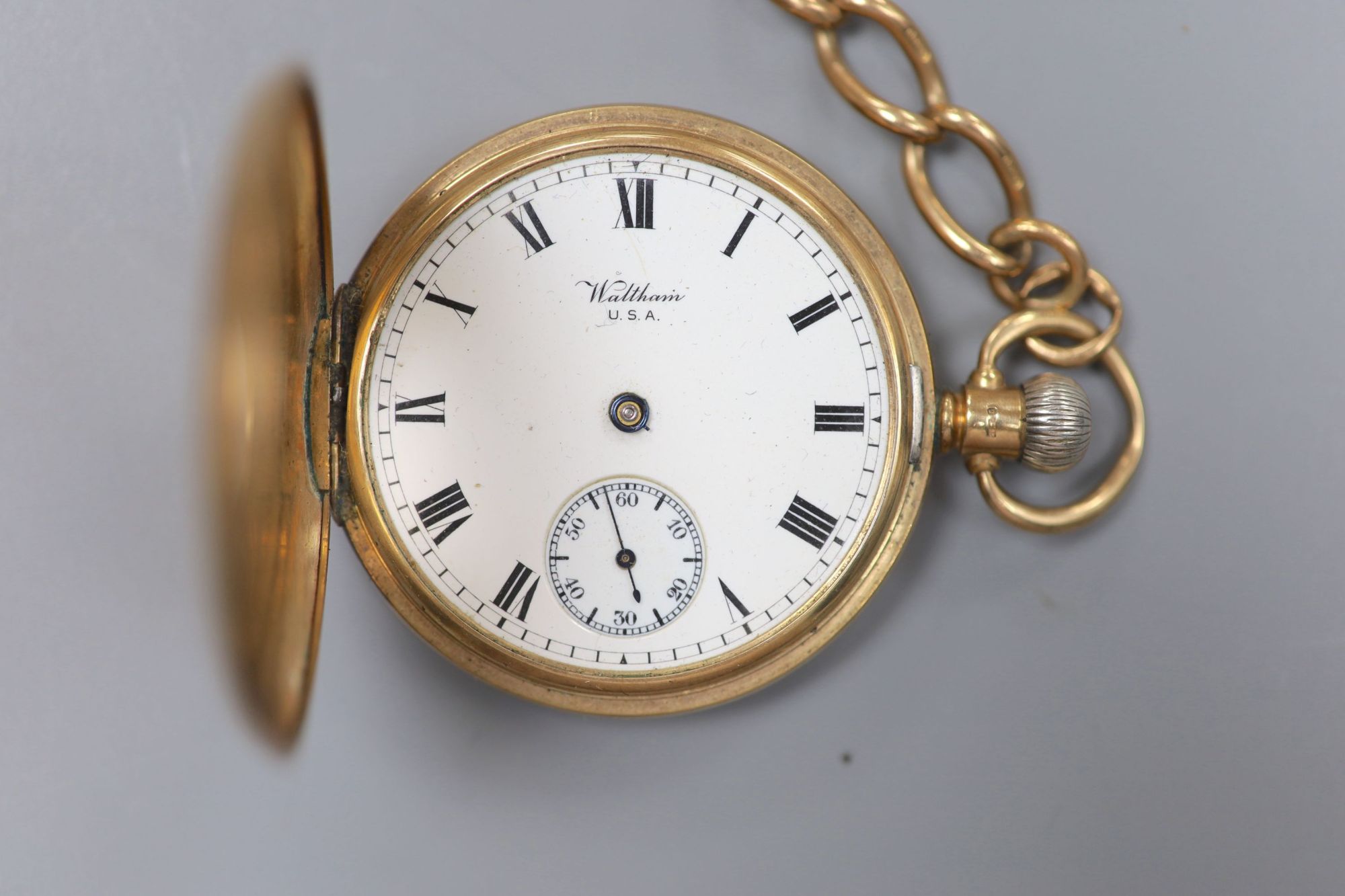 A George V 9ct gold Waltham half hunter pocket watch, with a 9ct gold albert.